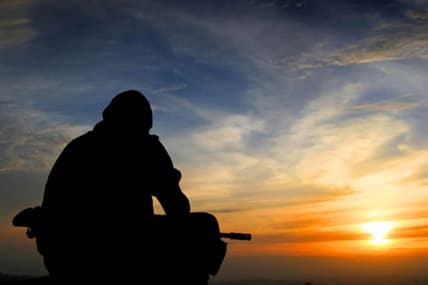 Man looking off into sunset